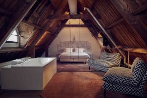 a room with a wooden table one of the romantic hotels in Amsterdam for your proposal