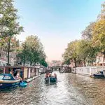 a group of people in a small boat in a body of water