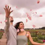 Couple at tulipgarden throwing flower pedals