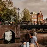 Couple kissing canals Amsterdam