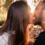 a close up of a man and a woman looking at the camera