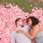 proposed couple on romantic flowerbed